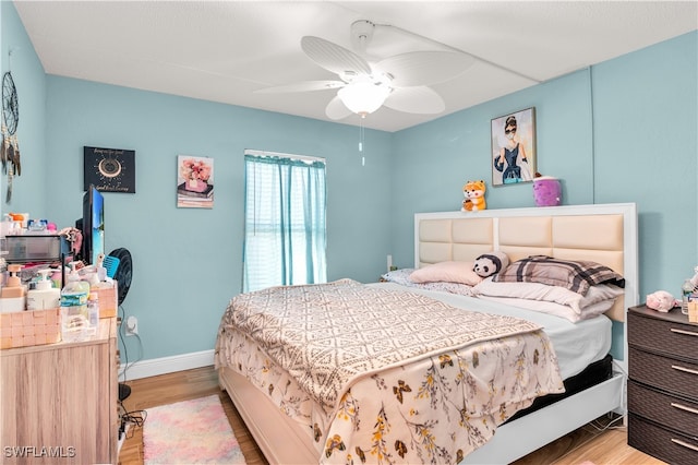 bedroom with light hardwood / wood-style flooring and ceiling fan