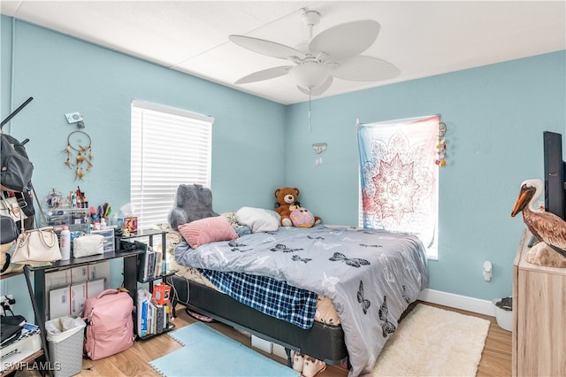 bedroom with ceiling fan and light hardwood / wood-style flooring