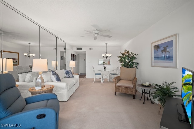 carpeted living room with ceiling fan with notable chandelier