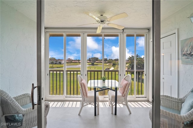 sunroom / solarium featuring ceiling fan and a wealth of natural light