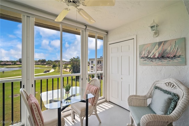 sunroom / solarium featuring ceiling fan