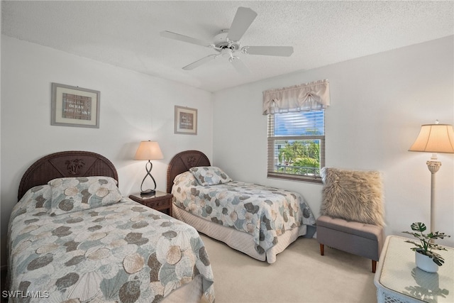 carpeted bedroom with a textured ceiling and ceiling fan