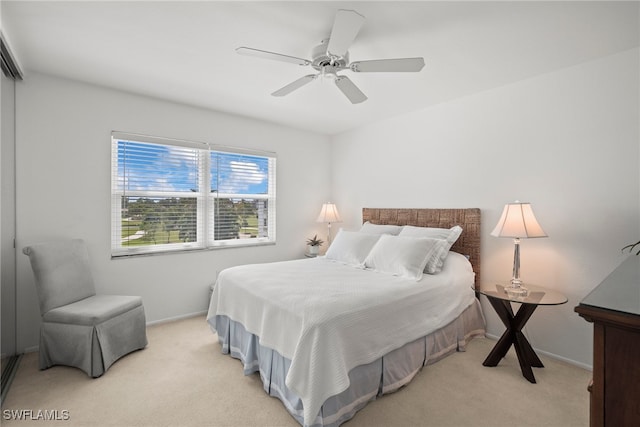 bedroom featuring ceiling fan and light colored carpet