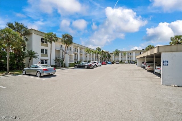 view of parking / parking lot featuring a carport