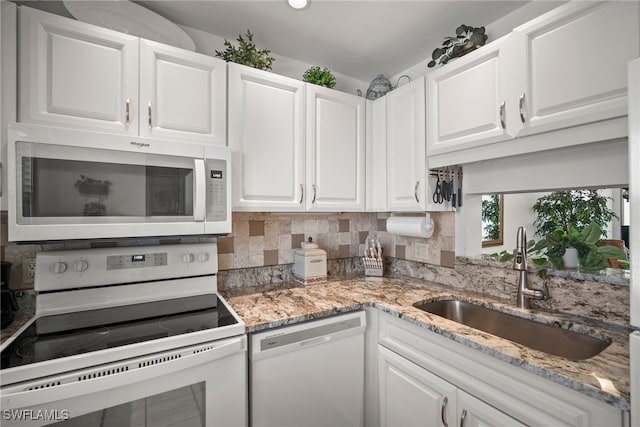 kitchen featuring white appliances, decorative backsplash, sink, and white cabinets