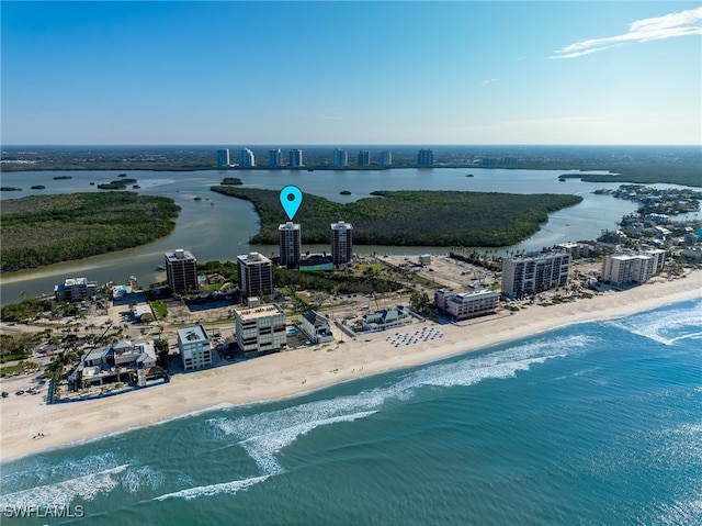 bird's eye view with a water view and a beach view