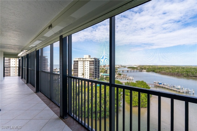 unfurnished sunroom with a water view