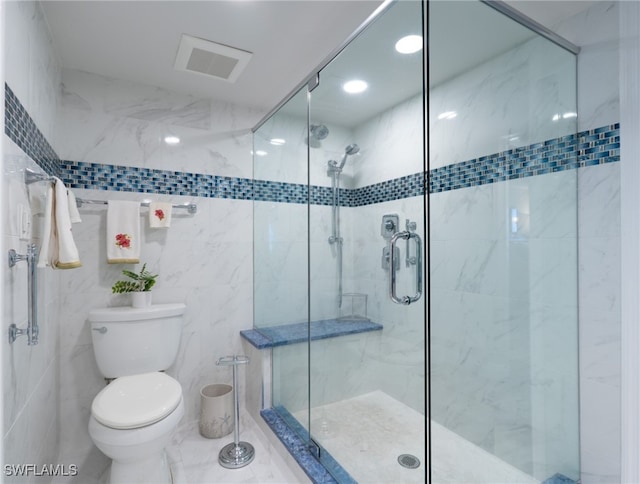 bathroom featuring tile walls, toilet, and walk in shower