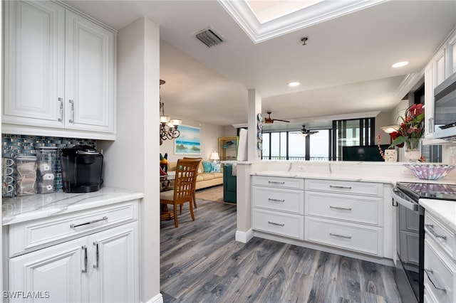 kitchen featuring black / electric stove, white cabinets, kitchen peninsula, and dark hardwood / wood-style flooring