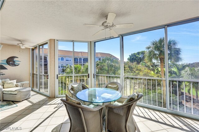 sunroom with ceiling fan and plenty of natural light