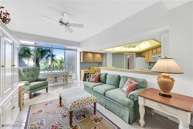 tiled living room featuring ceiling fan