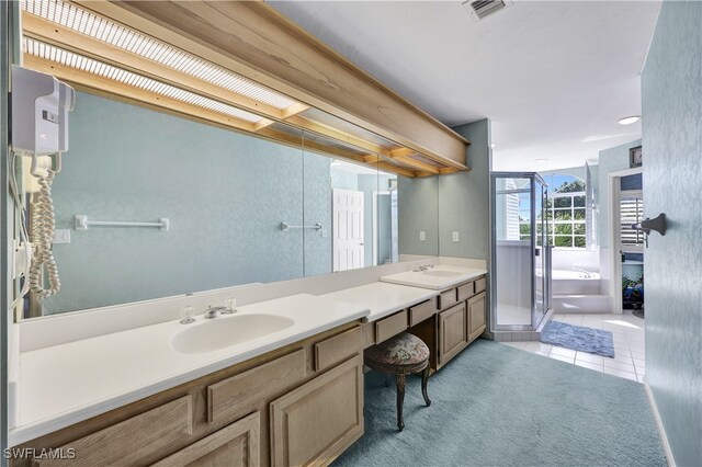 bathroom with vanity, shower with separate bathtub, and tile patterned flooring