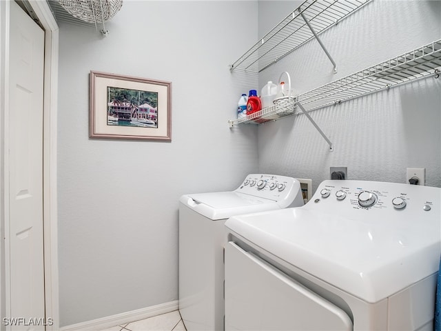 laundry area with light tile patterned flooring and washer and dryer