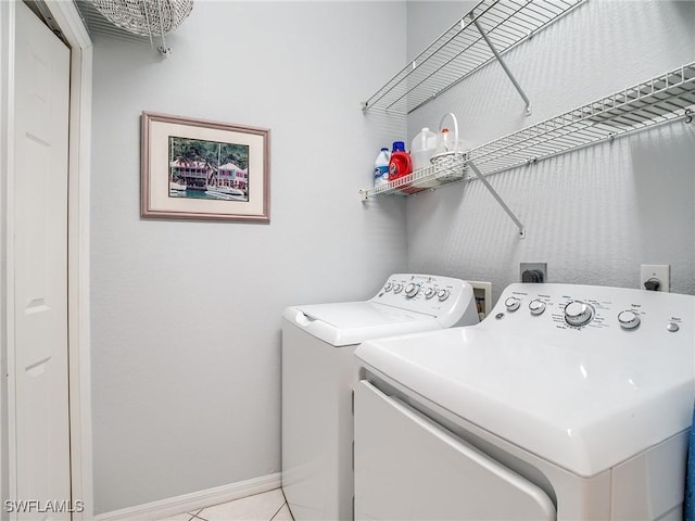 20011 Sanibel View Cir # 203, Fort Myers, FL 33908 - laundry area featuring washer and dryer, baseboards, and light tile patterned floors