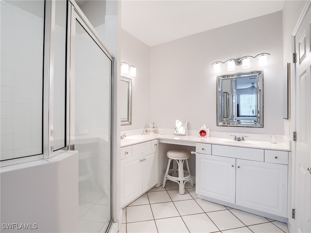 bathroom with tile patterned flooring, an enclosed shower, and vanity