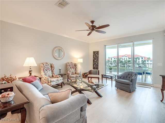 living room featuring light wood-type flooring, ceiling fan, and ornamental molding