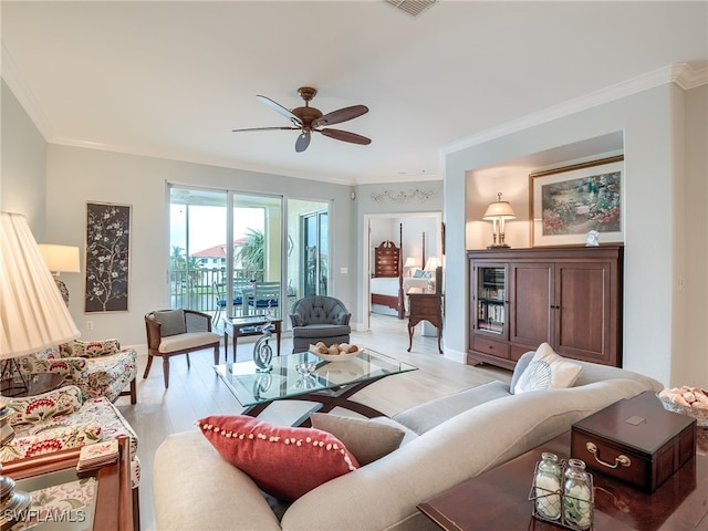 living room featuring ceiling fan, light wood-type flooring, and ornamental molding