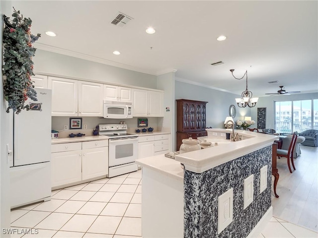 20011 Sanibel View Cir # 203, Fort Myers, FL 33908 - kitchen featuring white appliances, open floor plan, crown molding, white cabinets, and light countertops