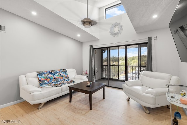 living room with a wealth of natural light and light hardwood / wood-style floors