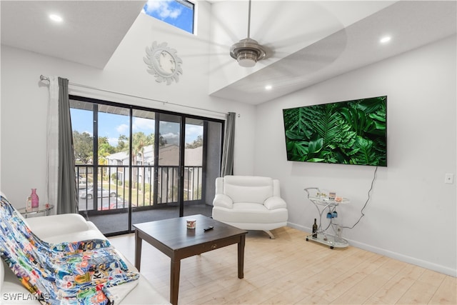 living room with hardwood / wood-style flooring and ceiling fan