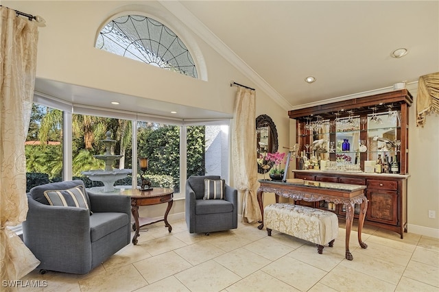 sitting room featuring a healthy amount of sunlight, light tile patterned flooring, and ornamental molding