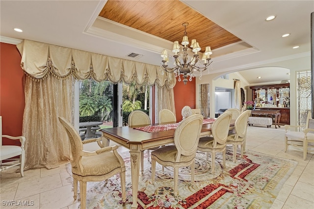 dining space with a notable chandelier, wood ceiling, crown molding, and a tray ceiling