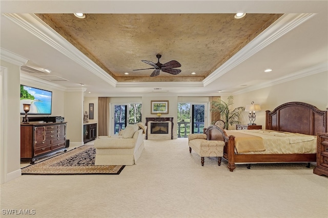 carpeted bedroom featuring a raised ceiling, access to exterior, ceiling fan, and ornamental molding