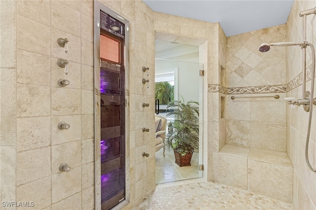 bathroom featuring tiled shower and ornamental molding