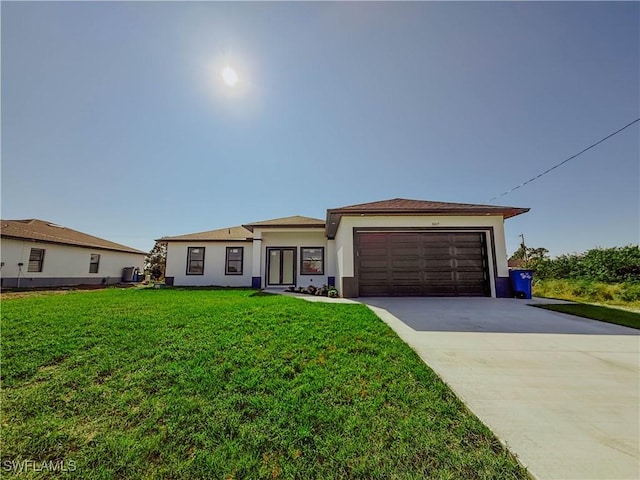 view of front of house featuring cooling unit, a garage, and a front yard