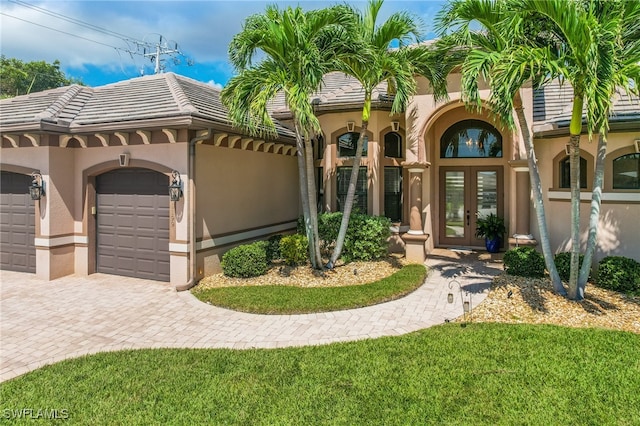 mediterranean / spanish-style house featuring french doors and a garage