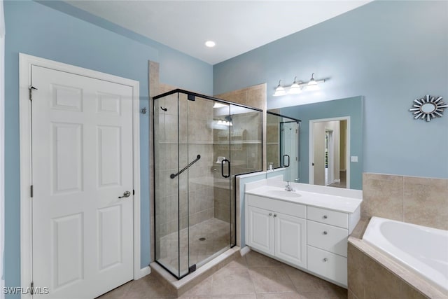 bathroom featuring shower with separate bathtub, vanity, and tile patterned floors