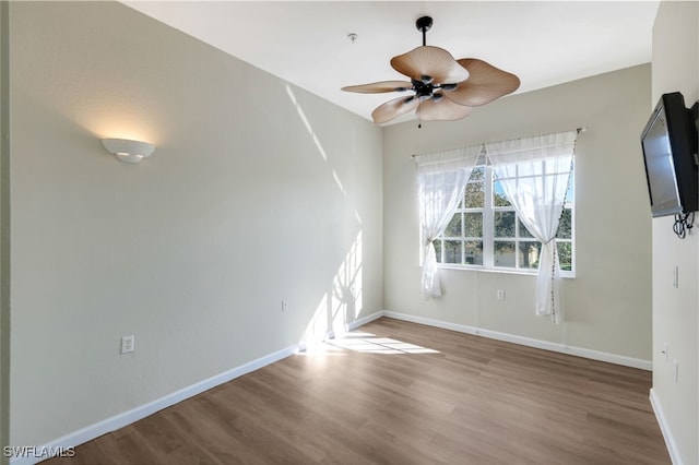 spare room with hardwood / wood-style flooring and ceiling fan