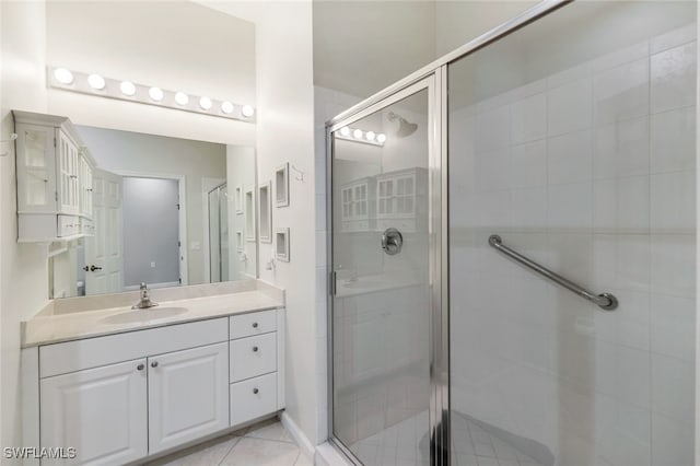 bathroom featuring an enclosed shower, vanity, and tile patterned floors