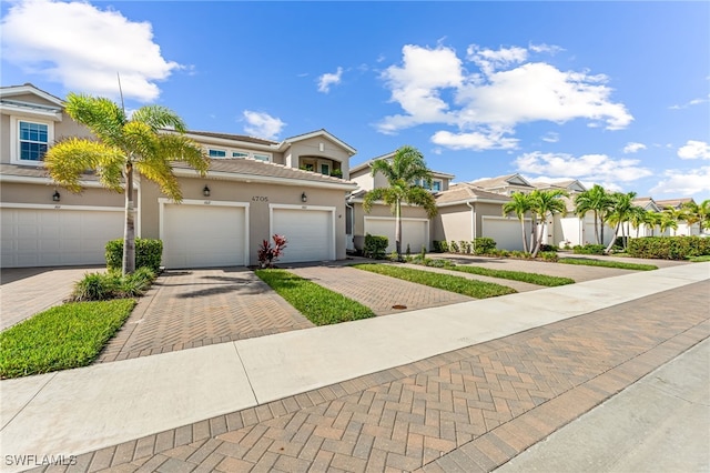 4705 Arboretum Cir Unit 202, Naples, FL 34112 - view of front of home with driveway, stucco siding, and a residential view