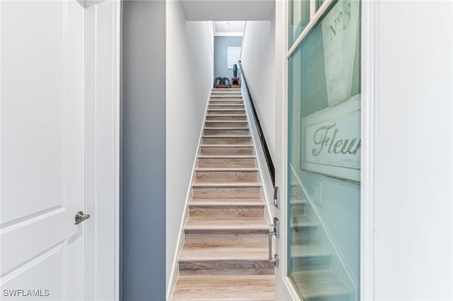 staircase with hardwood / wood-style flooring