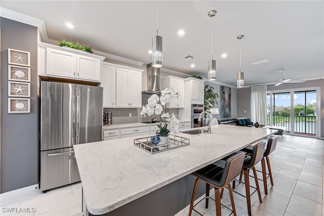 kitchen with white cabinets, appliances with stainless steel finishes, and a spacious island