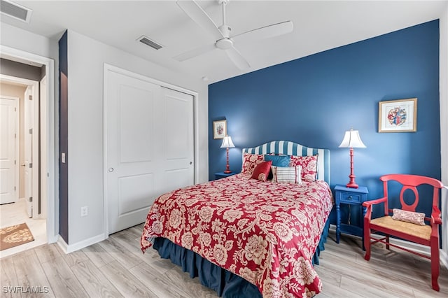 bedroom featuring ceiling fan, a closet, and light wood-type flooring