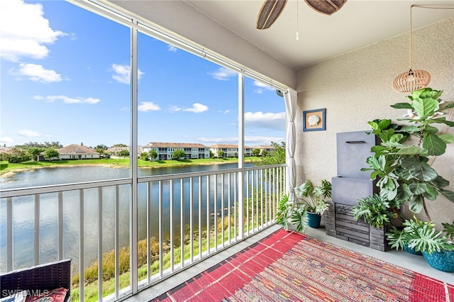 unfurnished sunroom with a water view and ceiling fan