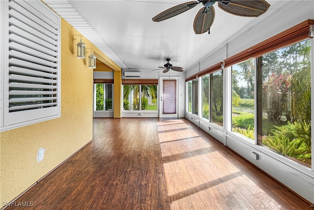 unfurnished sunroom featuring an AC wall unit and ceiling fan