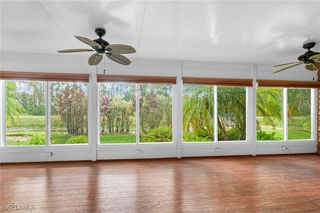 unfurnished sunroom featuring ceiling fan