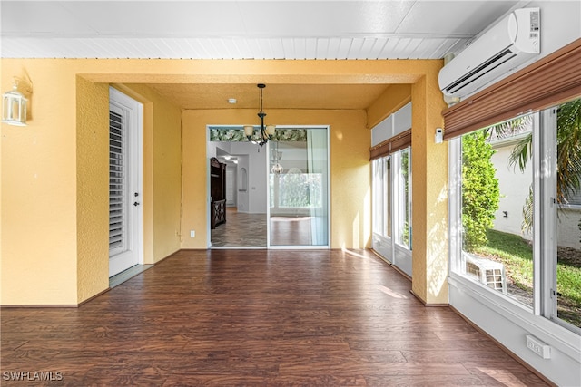 unfurnished sunroom featuring an AC wall unit