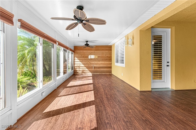 unfurnished sunroom with a healthy amount of sunlight and ceiling fan