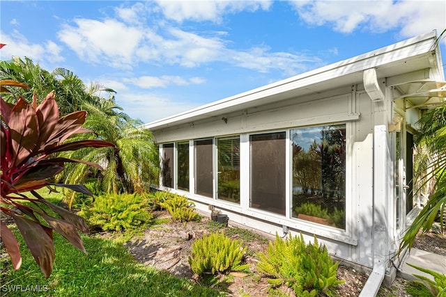 view of side of property featuring a sunroom