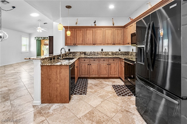 kitchen featuring kitchen peninsula, black appliances, sink, and decorative light fixtures