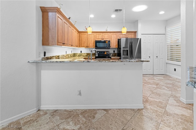 kitchen featuring hanging light fixtures, stone counters, kitchen peninsula, and appliances with stainless steel finishes