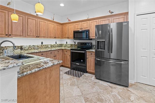 kitchen featuring pendant lighting, sink, black appliances, and light stone counters