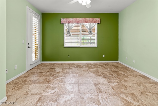 spare room featuring a wealth of natural light and ceiling fan