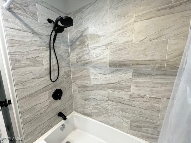 bathroom with shower / bathtub combination with curtain