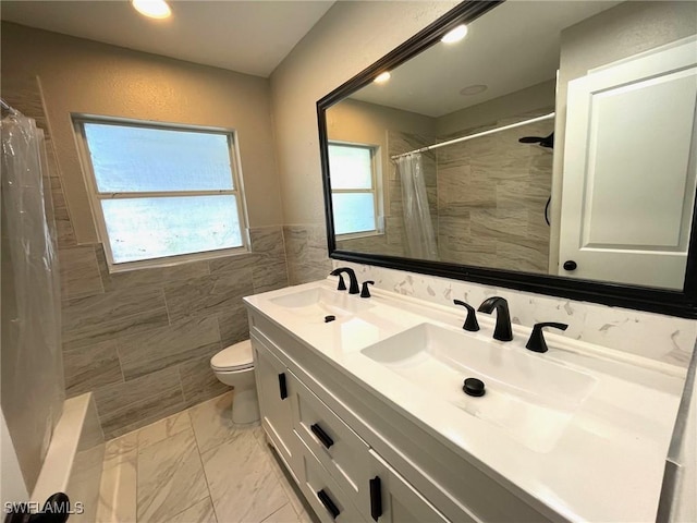 bathroom featuring toilet, tile walls, walk in shower, and vanity