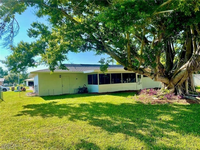 back of house featuring a yard